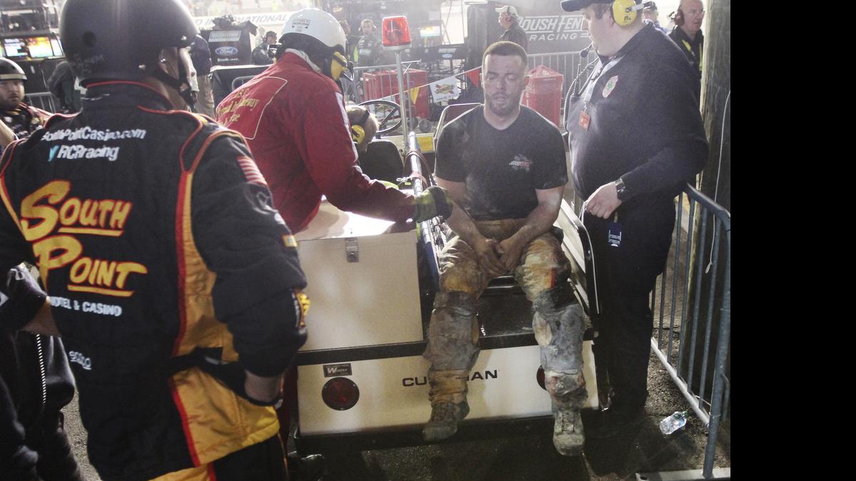 
An injured crew member receives medical attention after a fire on pit road during the NASCAR Xfinity series auto race at Richmond International Raceway, in Richmond, Va., April 24, 2015. 
