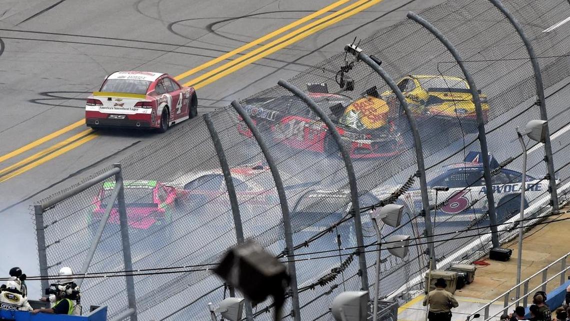 Kevin Harvick (4) drives past a late wreck involving Tony Stewart (14), David Gilliland (38), Danica Patrick (10) Trevor Bayne (6) during NASCAR’s Sprint Cup race Sunday at Talladega Superspeedway.