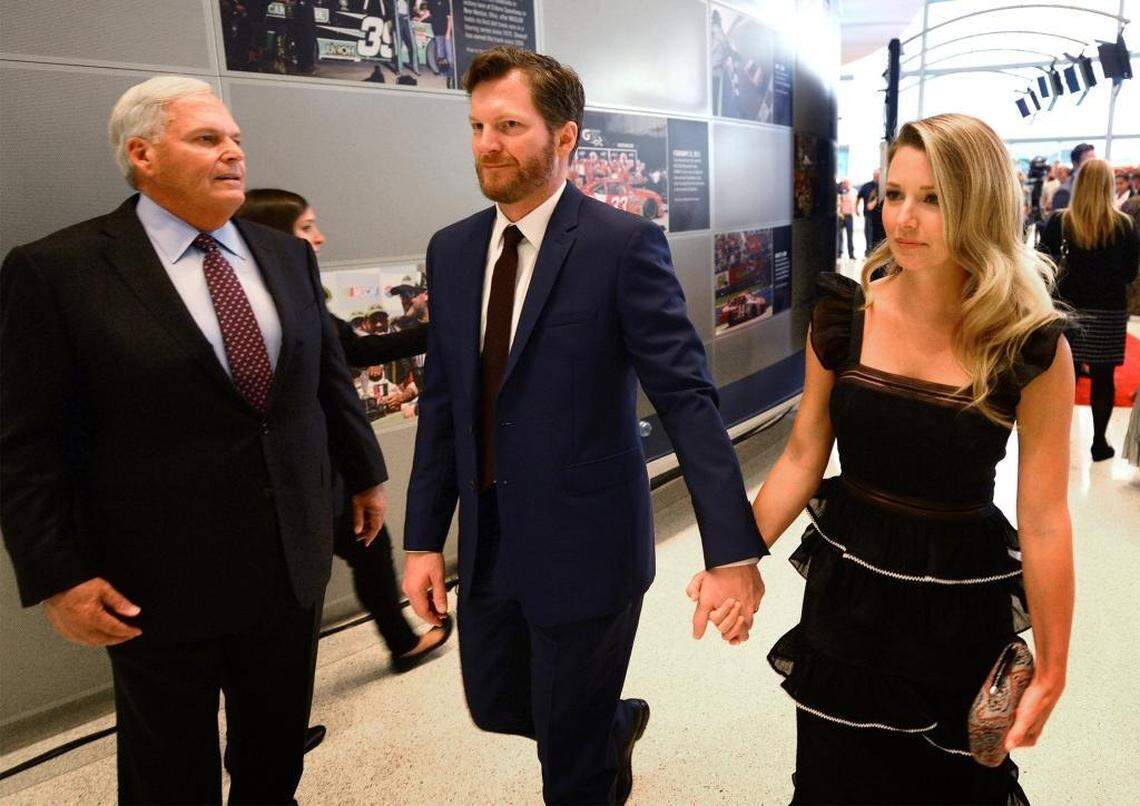 NASCAR driver Dale Earnhardt Jr., center, and his wife, Amy Earnhardt, first met in 2008 and were married last New Year’s Eve. Above, team owner Rick Hendrick, left, looks on as the couple attend the NASCAR Hall of Fame Induction ceremony in January.