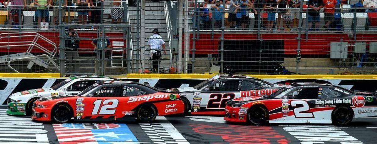 NASCAR Xfinity Series driver Ryan Blaney (12) and Kevin Harvick (partially hidden by Blaney’s car) battle on a restart in the closing laps of Saturday’s Hisense 4K TV 300 at Charlotte Motor Speedway. Blaney would go on to win the race.