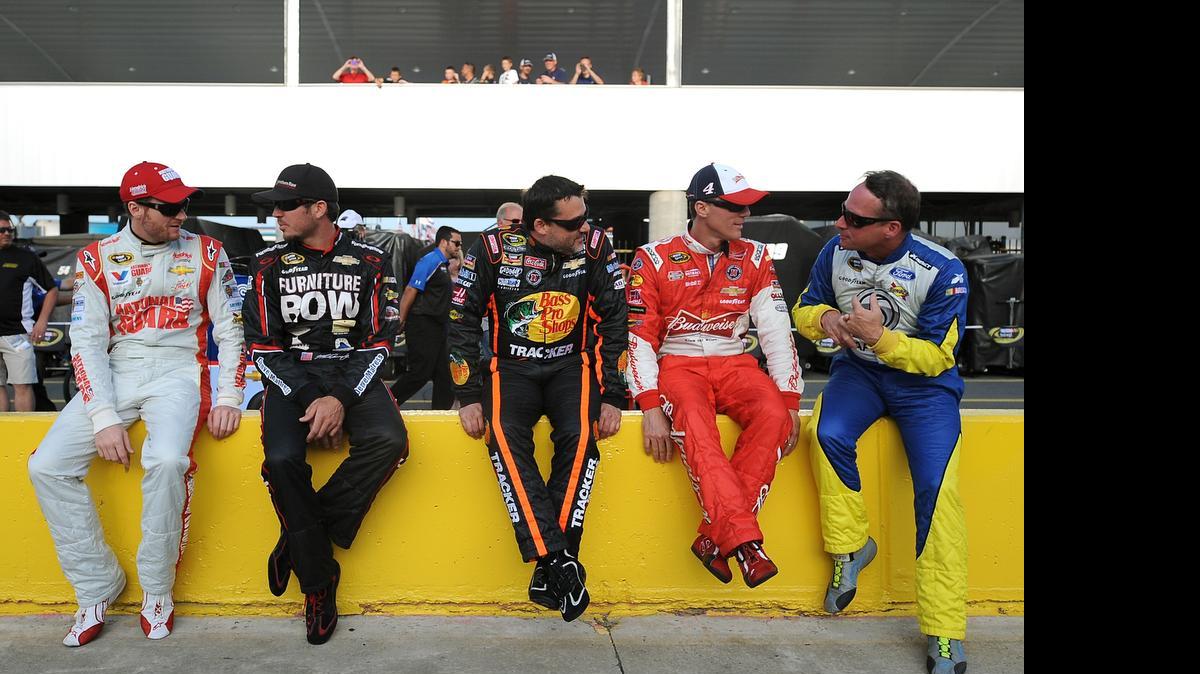 
NASCAR Sprint Cup Series drivers Dale Earnhardt Jr. (88), Martin Truex (78), Tony Stewart (14) , Kevin Harvick (4) and Dave Blaney (77) talk along pit road prior to qualifying for the Coca-Cola 600 on May 22, 2014 at Charlotte Motor Speedway.
