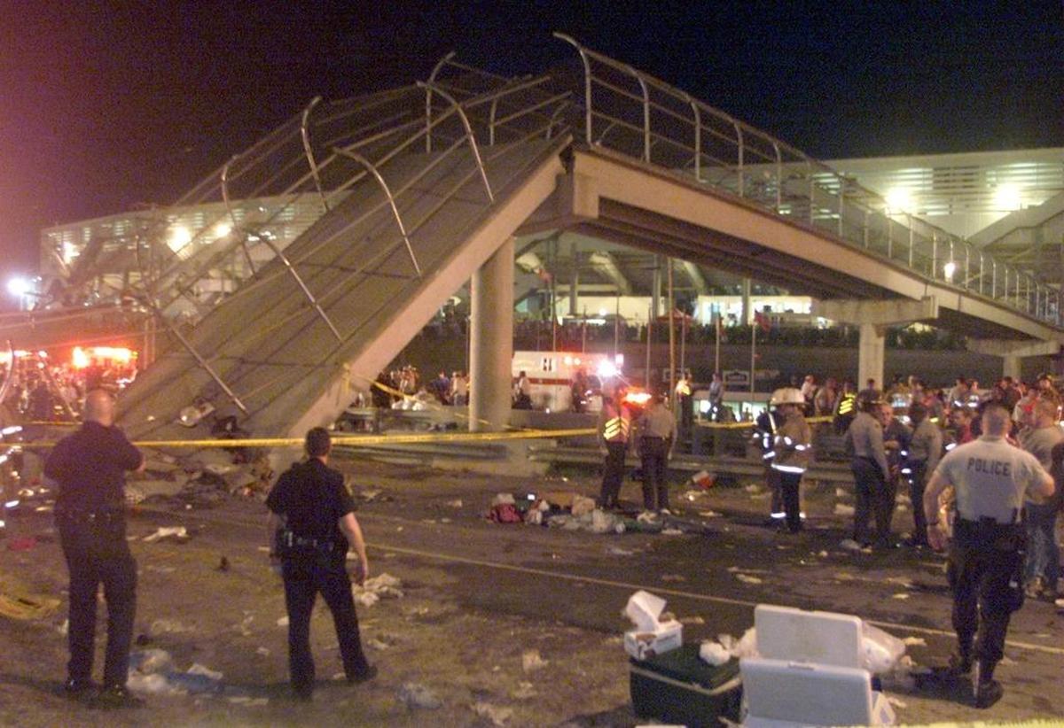 Emergency workers block off the area surrounding the pedestrian bridge that collapsed outside what is now Charlotte Motor Speedway on May 20, 2000.