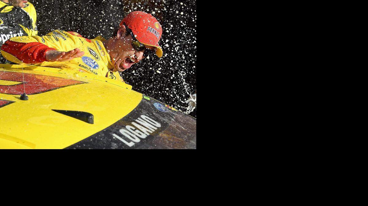 
Joey Logano slaps the roof of his car as he emerges with the victory Sunday in the Daytona 500. Logano surged ahead of the pack on a two-lap sprint to the finish and had command when a wreck behind him brought out a caution that allowed him to coast to the finish line. 
