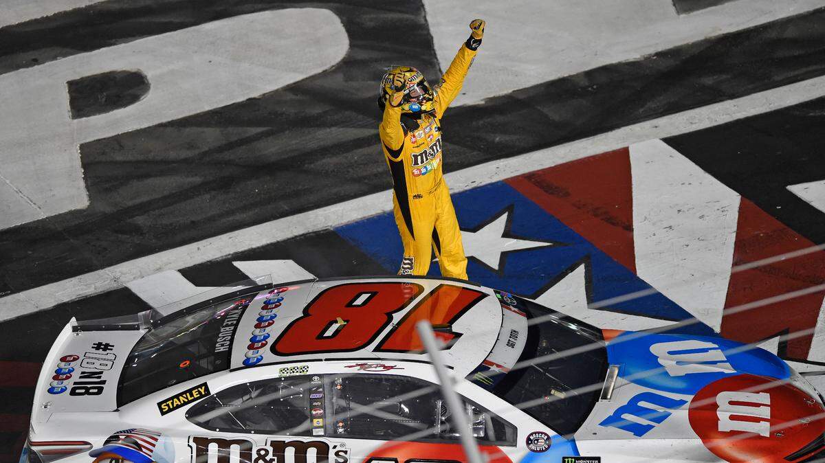 Kyle Busch celebrates after winning the NASCAR Cup Series auto race at Charlotte Motor Speedway in Charlotte, N.C., Sunday, May 27, 2018. (AP Photo/Mike McCarn)