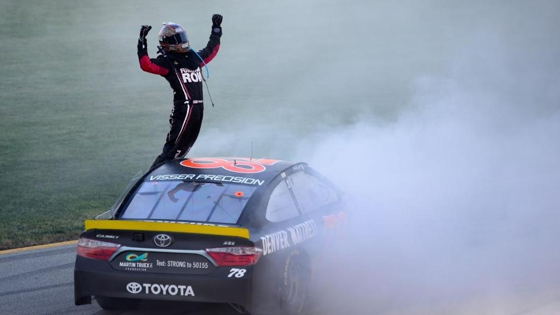 Martin Truex Jr. celebrates after winning Sunday’s NASCAR Sprint Cup Series Teenage Mutant Ninja Turtles 400 at Chicagoland Speedway.