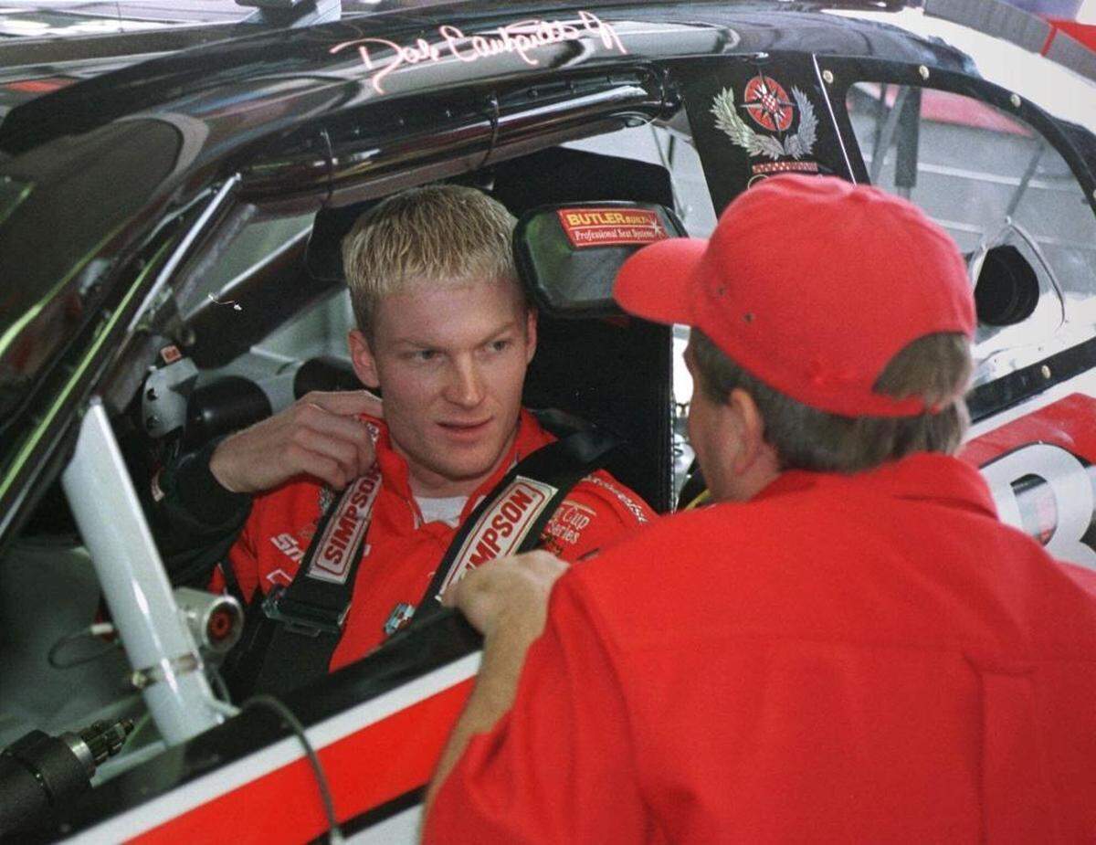 Dale Earnhardt, Jr., left, listens to a crew member as he sits in his Winston Cup race car before a May 5, 1999 practice session at Charlotte Motor Speedway in Concord. Earnhardt, then the NASCAR Busch Grand National (now the Xfinity Series) champion, was attempting to qualify for his first Cup Series race in the Coca-Cola 600.