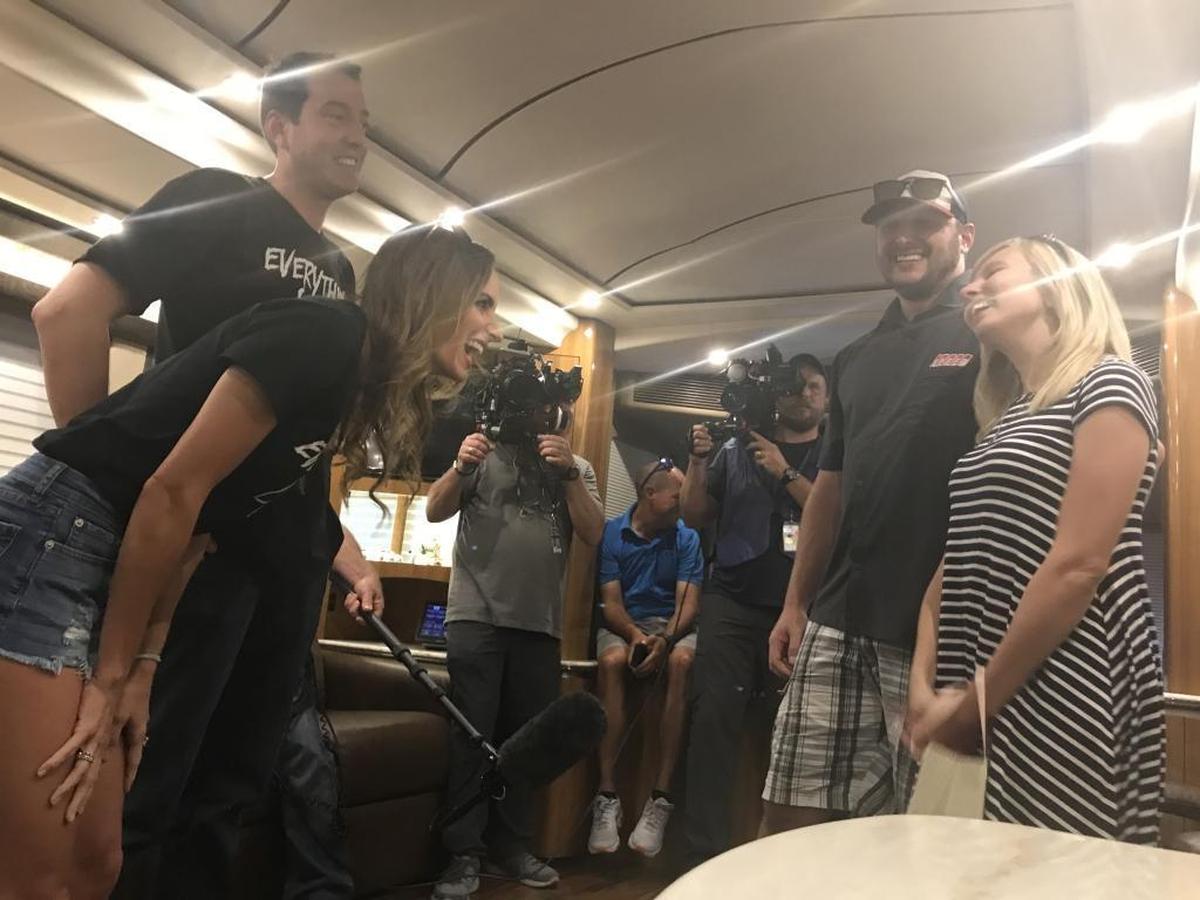 Kyle and Samantha Busch, left, surprise a couple with a Bundle of Joy grant at Charlotte Motor Speedway Saturday afternoon.