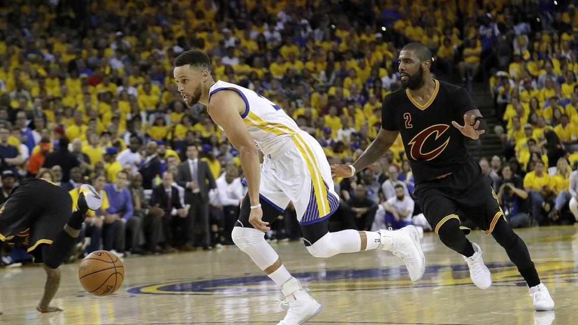 Golden State Warriors guard Stephen Curry, left, dribbles past Cleveland Cavaliers guard Kyrie Irving (2) during the first half of Game 2 of basketball's NBA Finals in Oakland, Calif., Sunday, June 4, 2017. (AP Photo/Marcio Jose Sanchez)