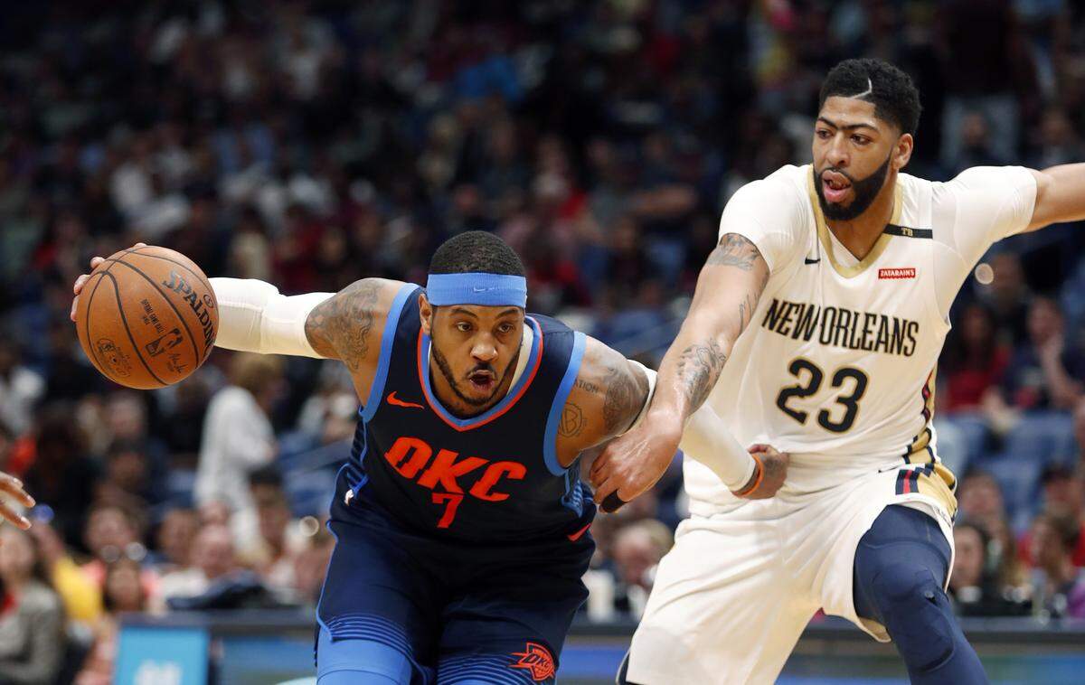 Oklahoma City Thunder forward Carmelo Anthony (7) drives to the basket against New Orleans Pelicans forward Anthony Davis (23) during the first half of an NBA basketball game in New Orleans, Sunday, April 1, 2018. (AP Photo/Gerald Herbert)