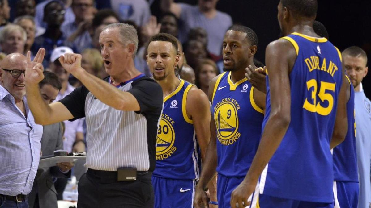 Referee Scott Wall, left, calls Golden State Warriors guard Stephen Curry (30) for a foul as Curry and Warriors forwards Andre Iguodala (9), and Kevin Durant (35) react during the second half of an NBA basketball game Saturday, Oct. 21, 2017, in Memphis, Tenn. Curry and Durant were ejected after arguing with Wall over the call. (AP Photo/Brandon Dill)