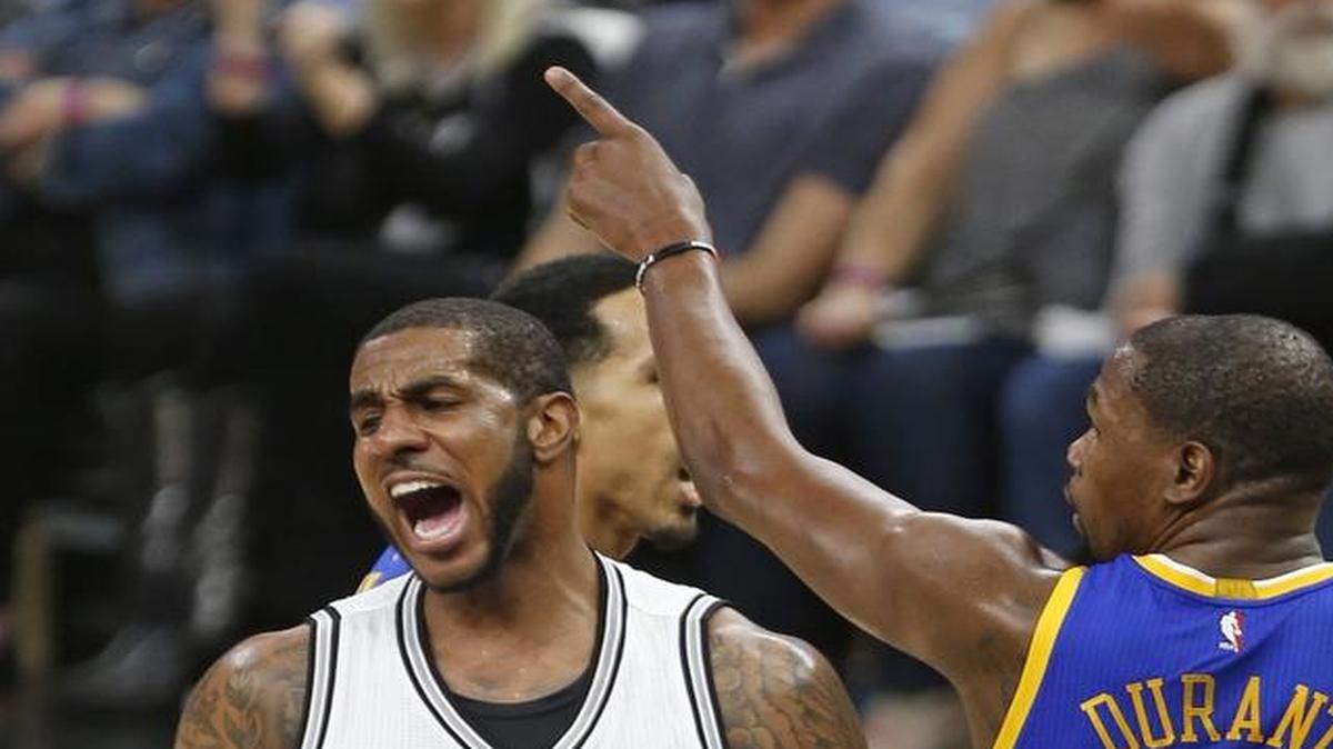 San Antonio Spurs forward LaMarcus Aldridge(12) reacts after missing a shot as Golden State Warriors forward Kevin Durant (35) gestures during the first half in Game 3 of the NBA basketball Western Conference finals on Saturday, May 20, 2017, in San Antonio. (AP Photo/Ronald Cortes)