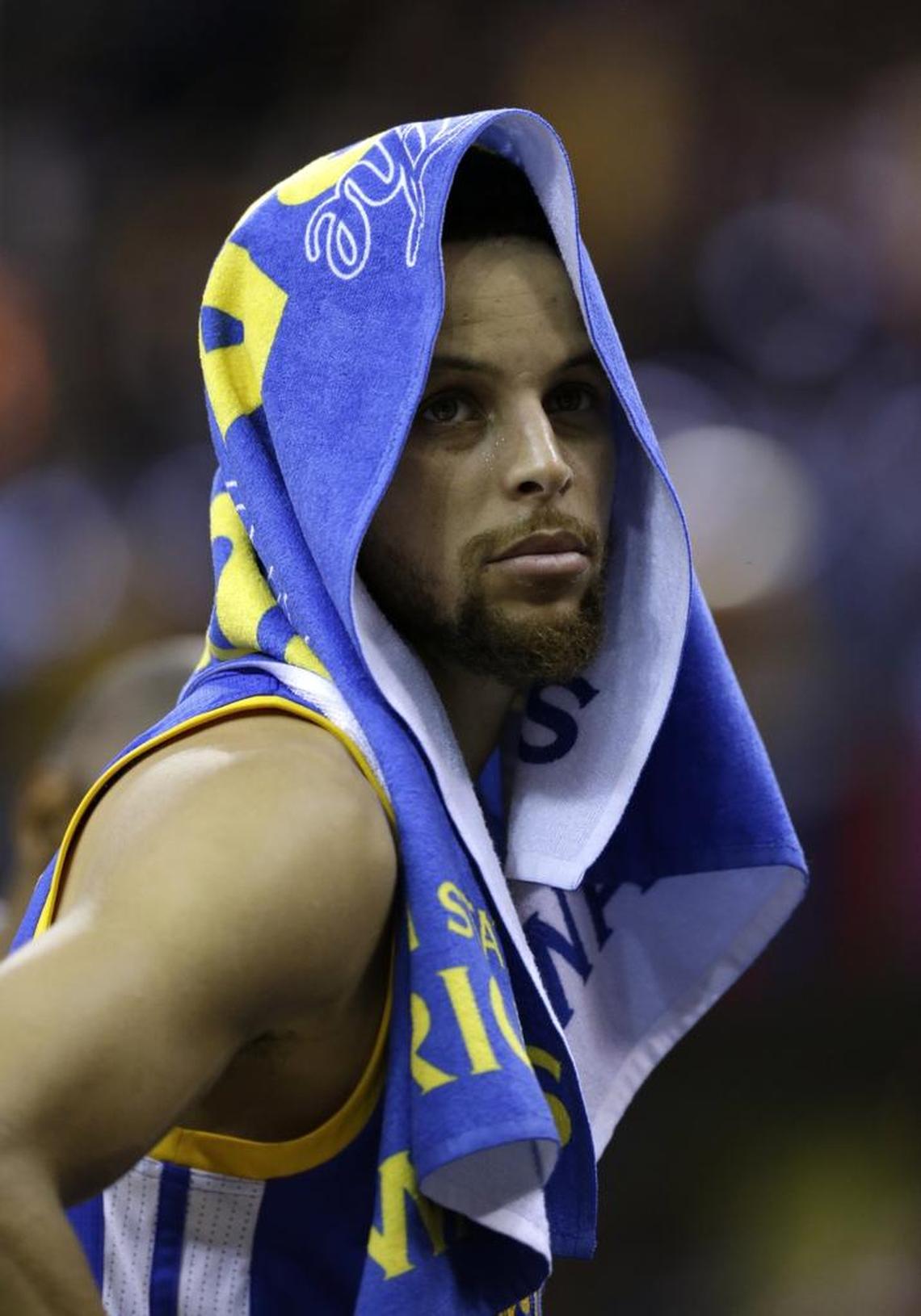 Golden State Warriors guard Stephen Curry (30) watches from the bench against the Cleveland Cavaliers during the second half of Game 3 of basketball's NBA Finals in Cleveland, Wednesday, June 7, 2017. (AP Photo/Tony Dejak)