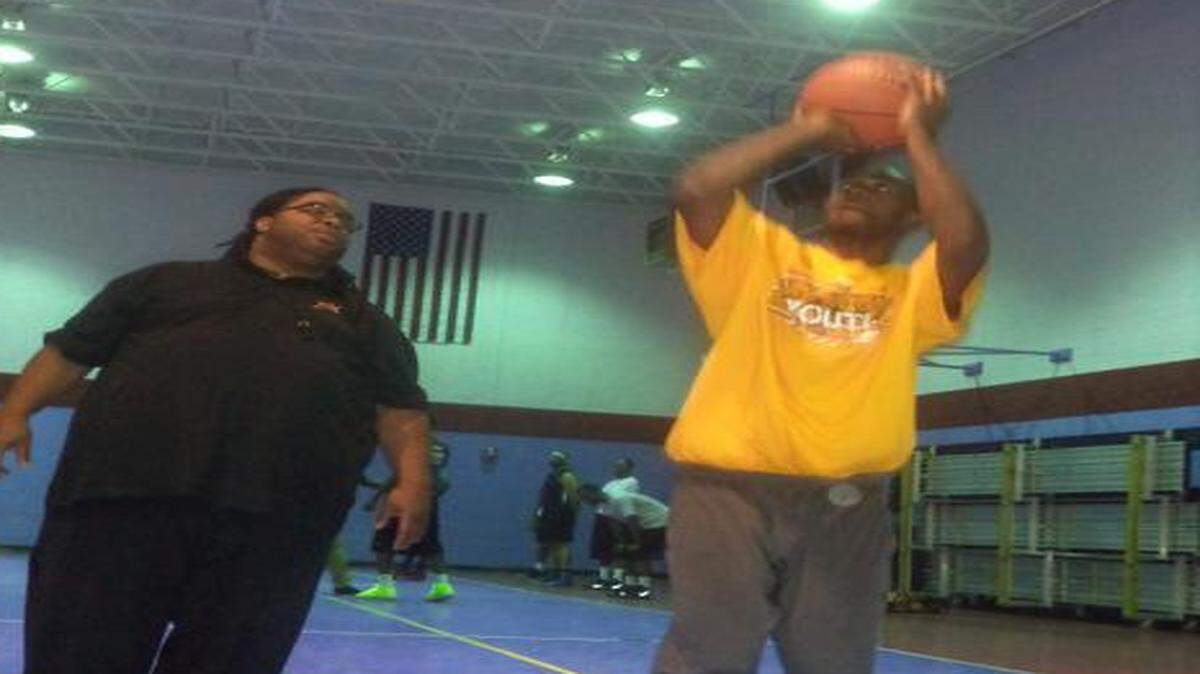 
Queen City Express coach William Enders, left, works on shooting with player Alexander Gunn.
