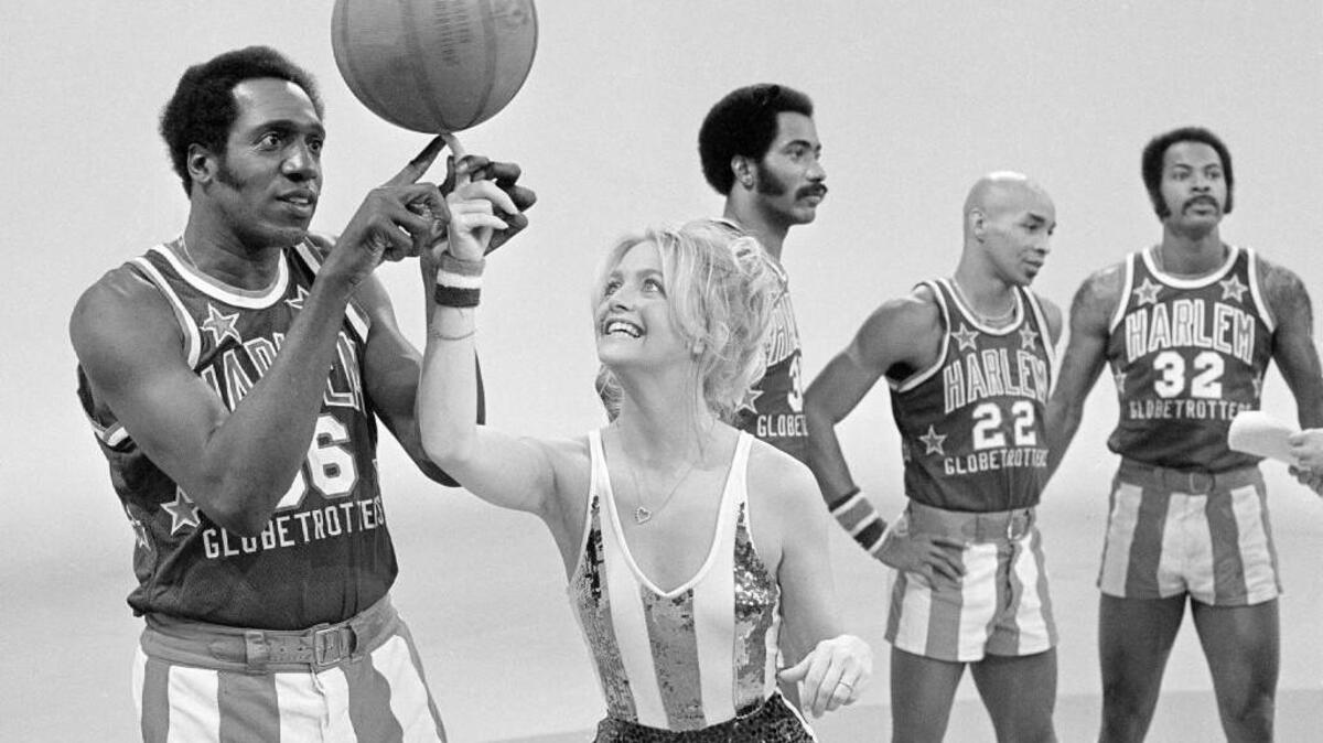 A 1978 photo shows actress Goldie Hawn with Harlem Globetrotters' Meadowlark Lemon.