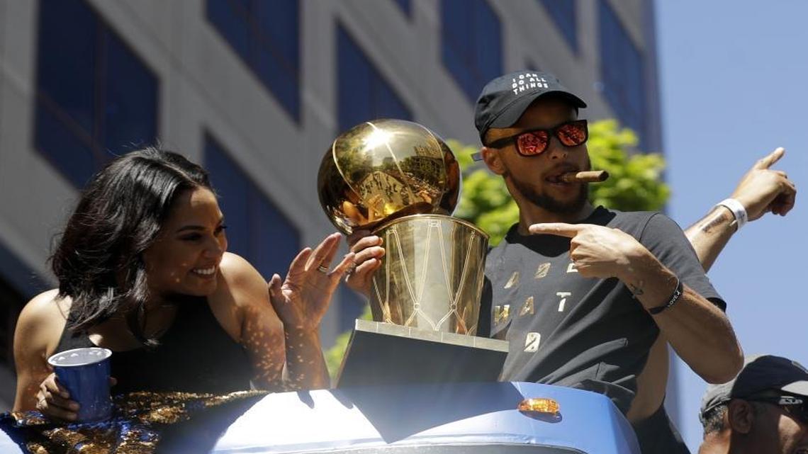 Golden State Warriors' Stephen Curry, right, and his wife Ayesha wave at fans during a parade and rally Thursday in Oakland, Calif., celebrating the team’s 2017 NBA championship.