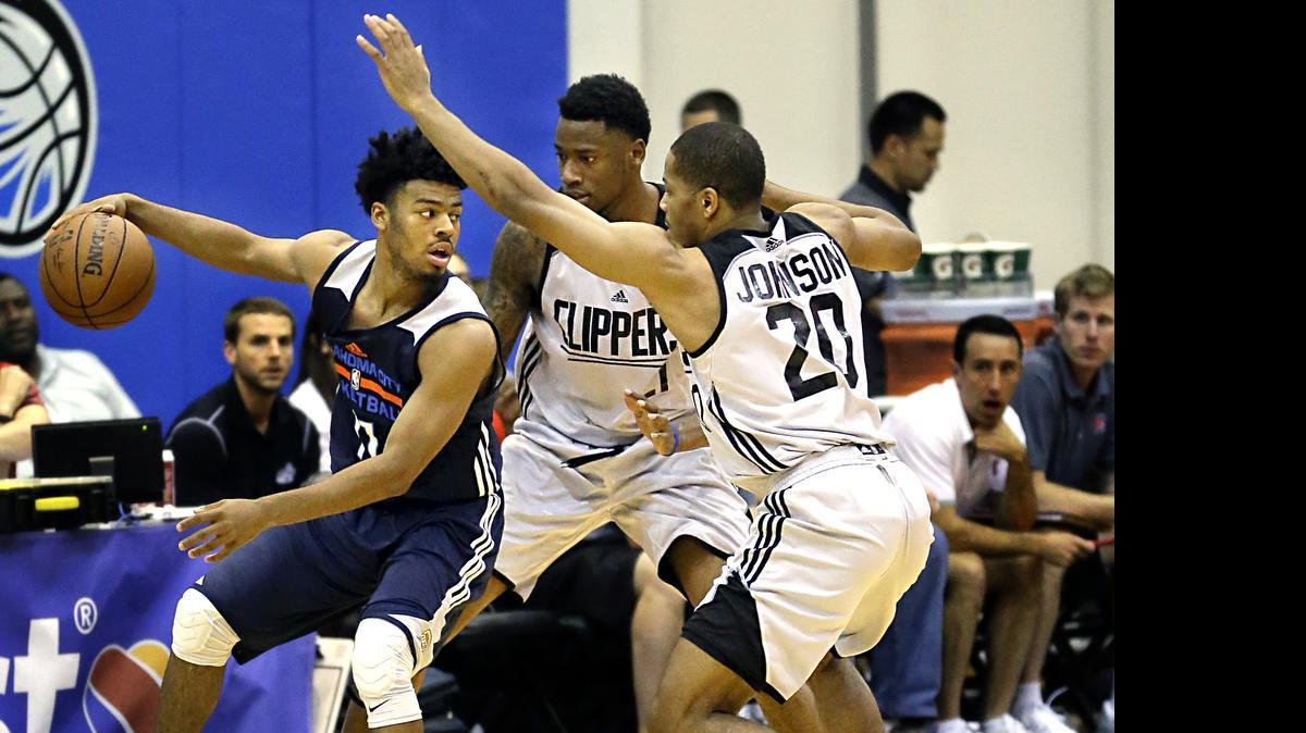 
Oklahoma City Thunder's Quinn Cook, left, looks to pass the ball as he is guarded by Los Angeles Clippers' Brandon Dawson, center, and Geron Johnson (20) during the second half of an NBA summer league basketball game, Tuesday, July 7, 2015, in Orlando, Fla. 
