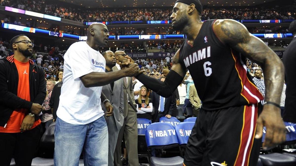 Charlotte Bobcats' team owner Michael Jordan shakes hands with Miami Heat's LeBron James (6) after the Heat won, 109-98, in Game 4 of the first round of the Eastern Conference playoff series at Time Warner Cable Arena on April 28, 2014. Radio host Colin Cowherd thinks James is the biggest threat yet to Jordan’s all-time greatest player status.