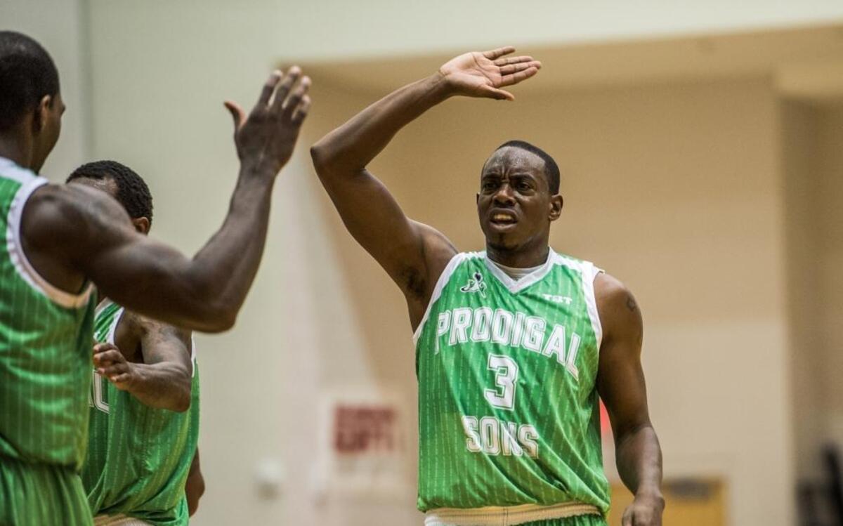 Nate Chambers high-fives a teammate from NC Prodigal Sons, one of four teams that won Sunday at Queens to advance to the regional finals of The Basketball Tournament, a $2 million contest.