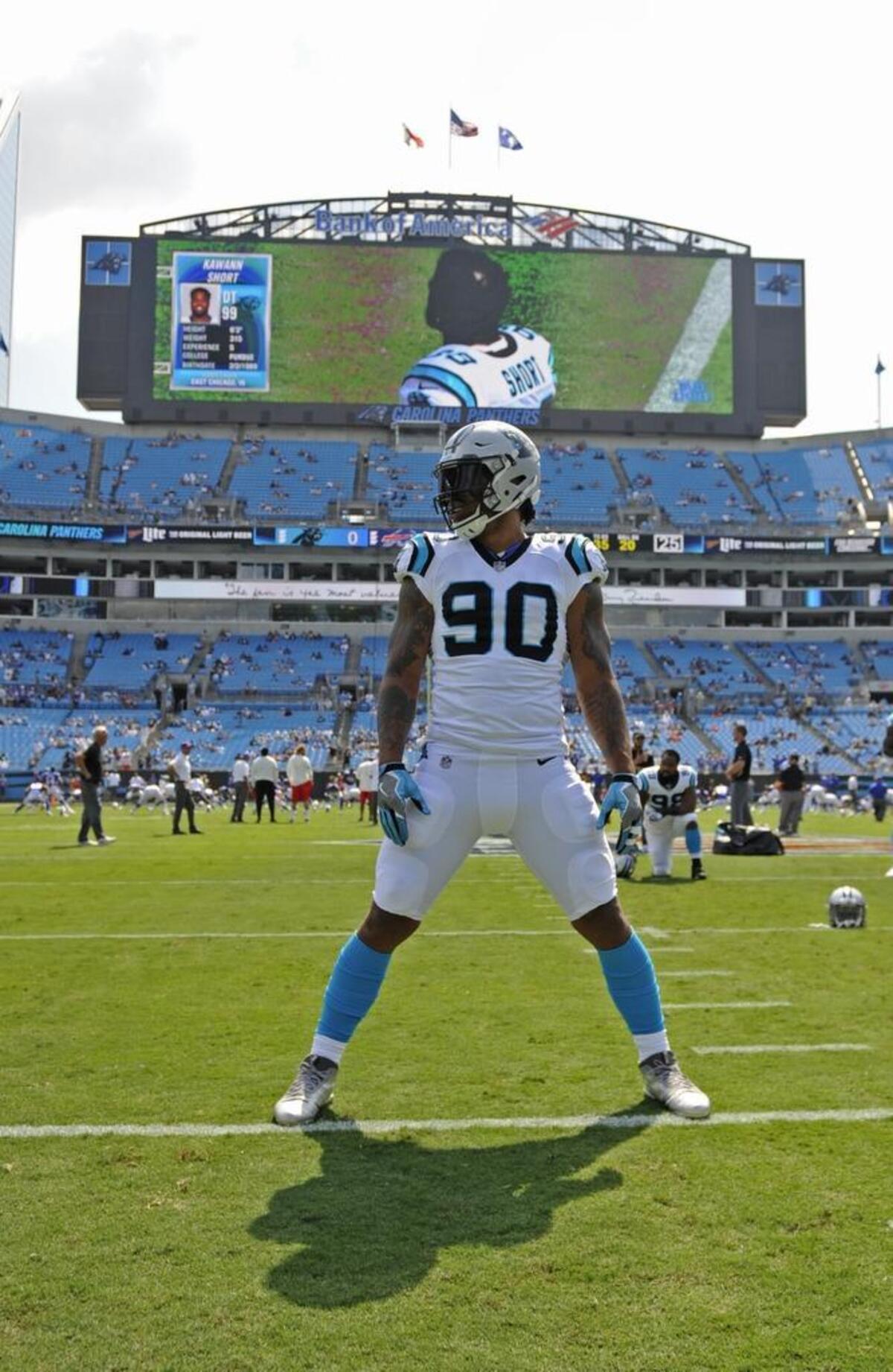 Julius Peppers (90) warms up before what was his first real home game for the Carolina Panthers since the 2009 season.