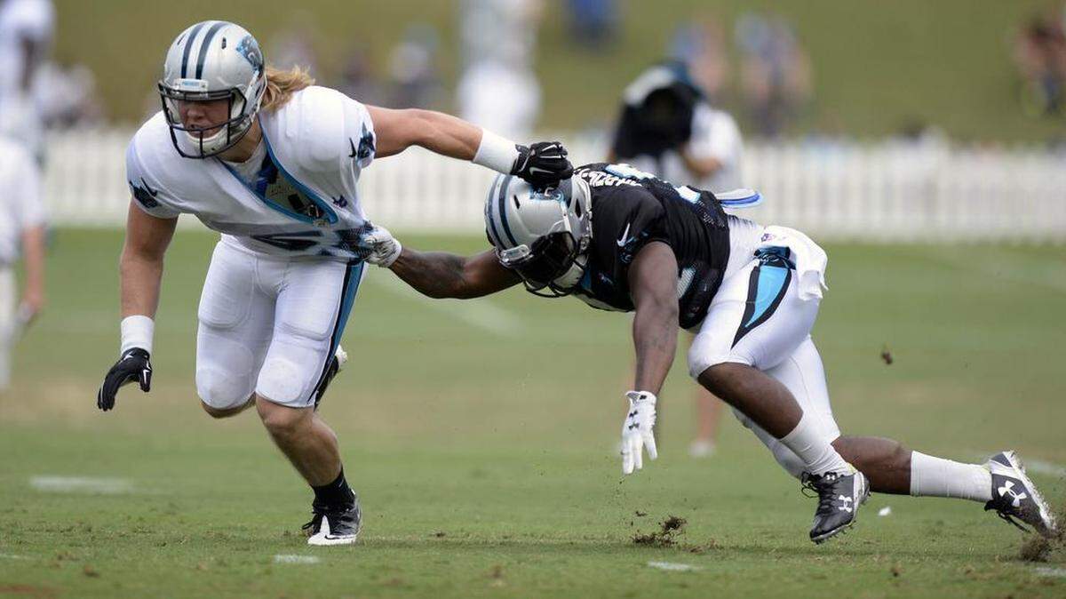 
Carolina Panthers linebacker David Mayo (55) gets past Cameron Artis-Payne (34) during a drill at Carolina Panthers Training Camp on Monday.

