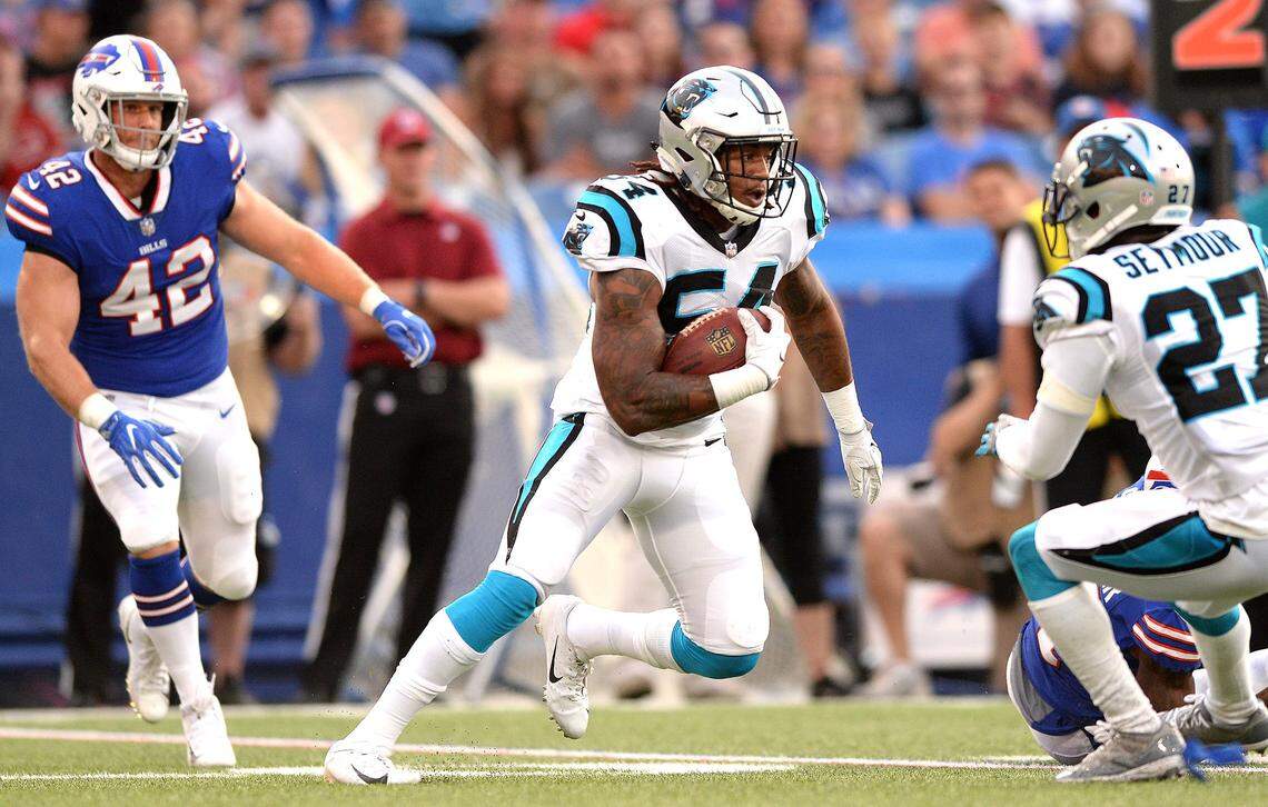 Carolina Panthers linebacker Shaq Thompson, center, rushes for yardage after intercepting a pass by the Buffalo Bills during NFL exhibition action at New Era Field in Orchard Park, NY on Thursday, August 9, 2018.