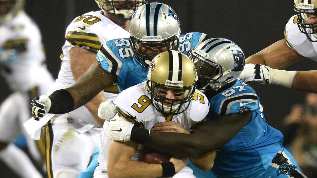 Carolina Panthers defensive end Mario Addison sacks New Orleans Saints quarterback Drew Brees (9) as defensive tackle Kawann Short (99) closes in during the second quarter at Bank of America Stadium on Thursday.