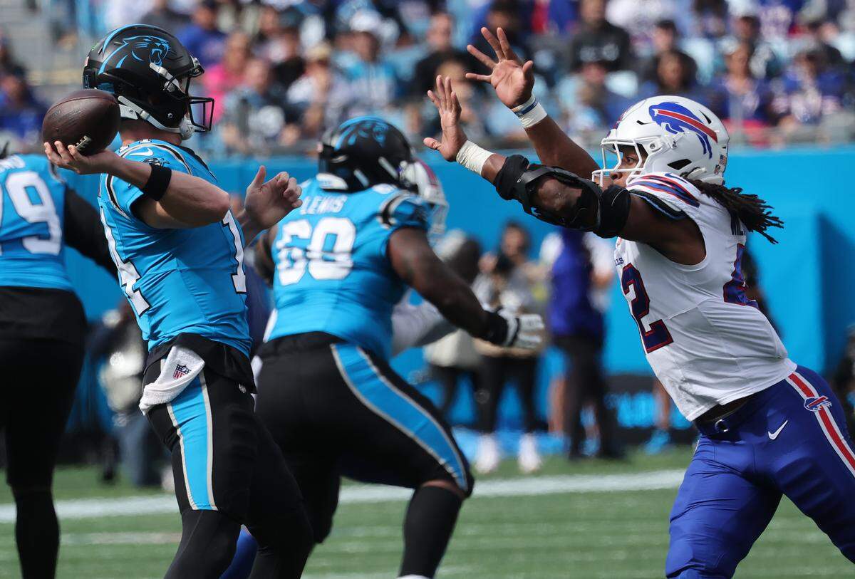 Carolina Panthers quarterback Andy Dalton looks for an opening as Buffalo Bills' Dorian Williams comes for the ball during Sunday’s game in Charlotte. 