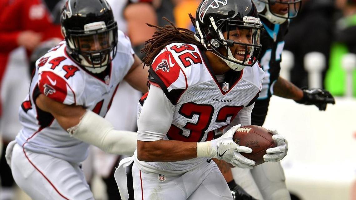Atlanta Falcons cornerback Jalen Collins smiles as he runs with the ball he intercepted on a pass by Carolina Panthers quarterback Cam Newton on Saturday. The Falcons’ victory officially eliminated the Panthers from the playoffs.