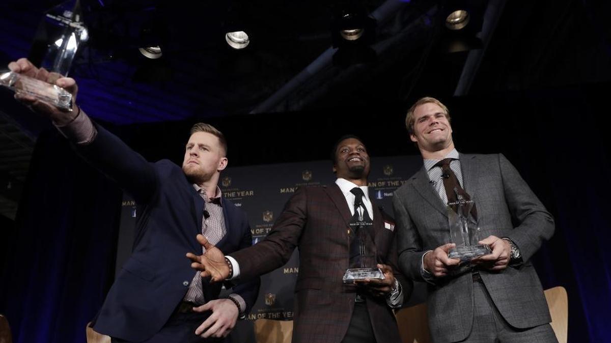 Walter Payton Man of the Year finalists, Houston Texans’ J.J. Watt, from left, Baltimore Ravens’ Benjamin Watson and Carolina Panthers’ Greg Olsen pose for a photo after Friday’s fan forum with commissioner Roger Goodell in Minneapolis, site of Super Bowl LII. The winner will be announced Saturday night.
