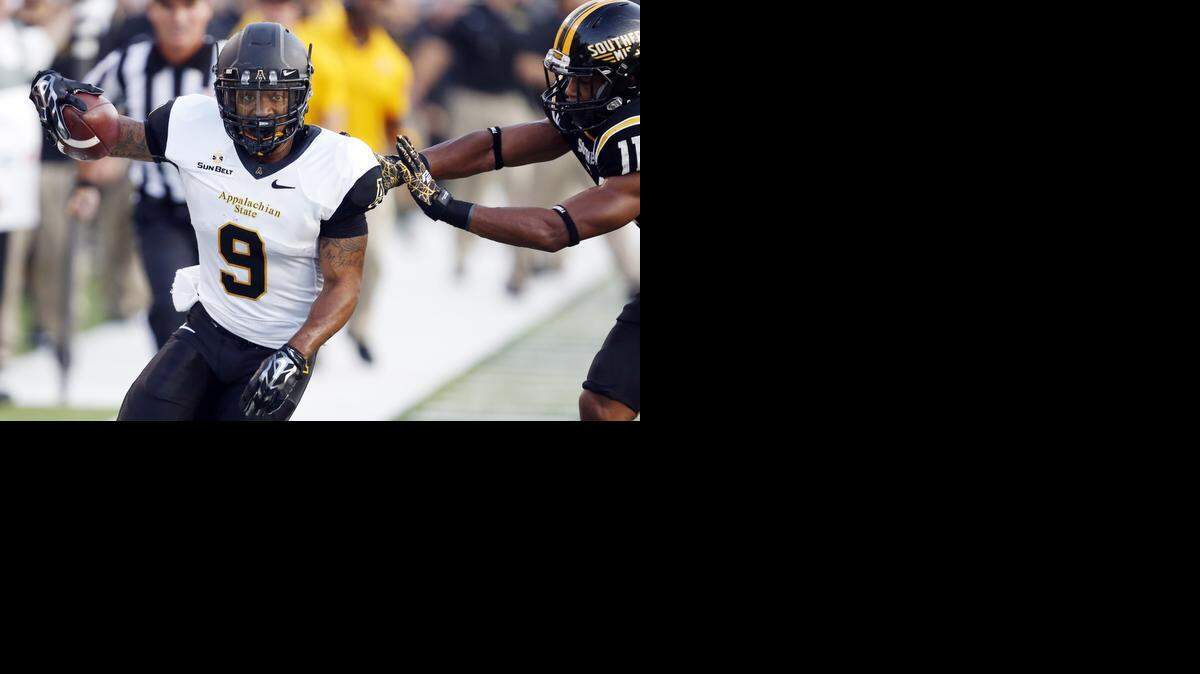 
Appalachian State wide receiver Tacoi Sumler (9) is pushed out of bounds by Southern Mississippi defensive back Kalan Reed after a short reception in the first half of an NCAA college football game in Hattiesburg, Miss., last season. 
