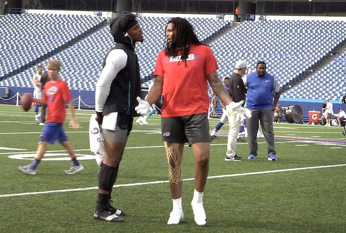 Buffalo Bills wide receiver Kelvin Benjamin, right, throws up his arms while being spoken to by Carolina Panthers quarterback Cam Newton, left, during a warmup period for the teams at New Era Field in Orchard Park, NY on Thursday, August 9, 2018. Benjamin made uncomplimentary statements about Newton and his time in Carolina last week. The team’s play an exhibition Thursday night.