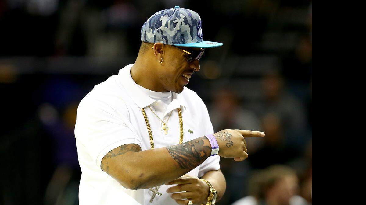 
Greg Hardy watches  a Charlotte Hornets game at Time Warner Cable Arena, Nov.  26, 2014 in Charlotte. 
