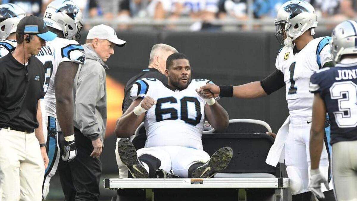 Carolina Panthers offensive tackle Daryl Williams (60) is consoled by Carolina Panthers quarterback Cam Newton (1) as he is prepared to be carted off the field during Sunday’s game against the Dallas Cowboys. Williams was placed on injured reserve on Tuesday morning.