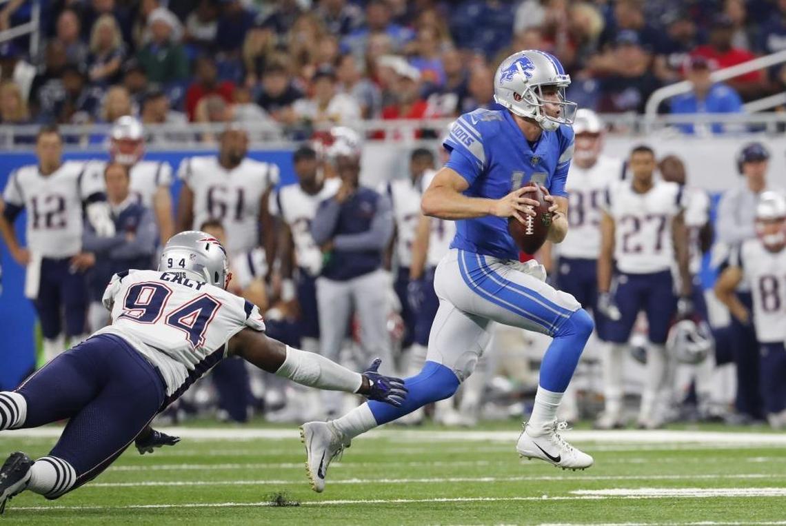 Detroit Lions quarterback Jake Rudock (14) breaks away from New England Patriots defensive end Kony Ealy (94) during the second half of Friday’s NFL preseason football game in Detroit. On Saturday, the Patriots cut Ealy.