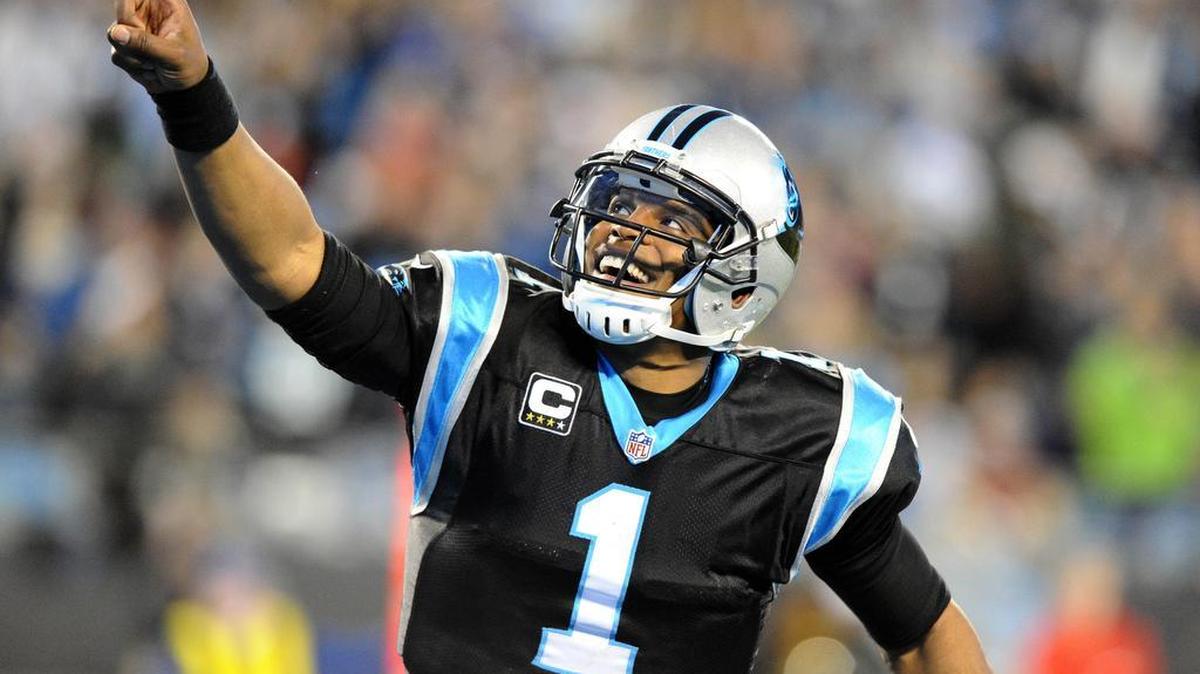 Carolina Panthers' Cam Newton (1) points to the crowd while celebrating a touchdown against the Tampa Bay Buccaneers in the second quarter at Bank of America Stadium on Sunday, January 3, 2016. The Panthers won 38-10, and secured home field through the playoffs.