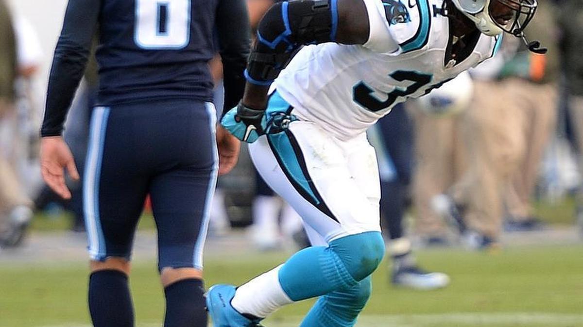 Carolina Panthers cornerback Charles Tillman limps off the field following a series against the Tennessee Titans.