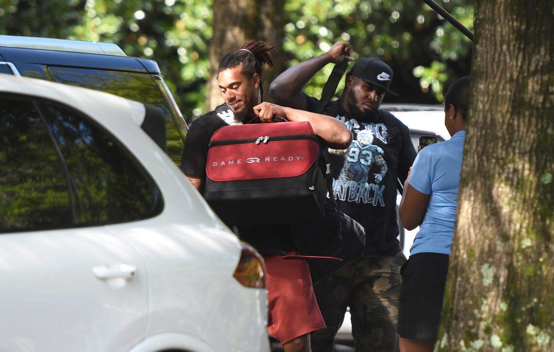 Carolina Panthers linebacker Shaq Thompson (54) and defensive tackle Kyle Love (93) unload the car as they arrive to training camp at Wofford College on Wednesday, July 25, 2018.