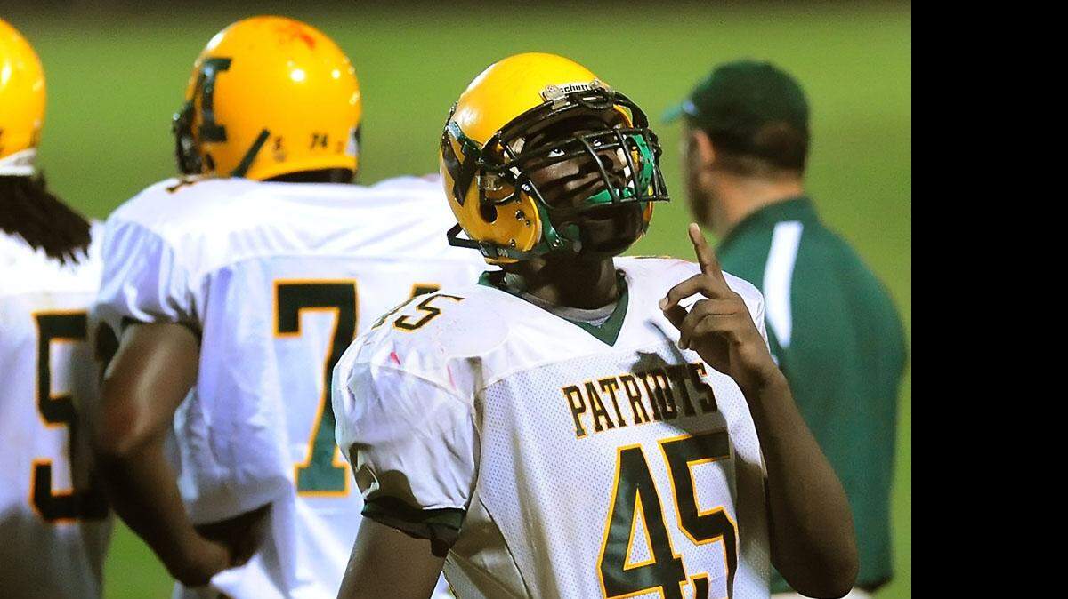 
On the day his mother, Barbara Wright, was buried, Zack Hodges points to the sky in her honor as he played for Independence High. His mother’s death in 2008 was the most devastating of several tragedies Hodges has faced. He now expects to be drafted in the 2015 NFL Draft.


