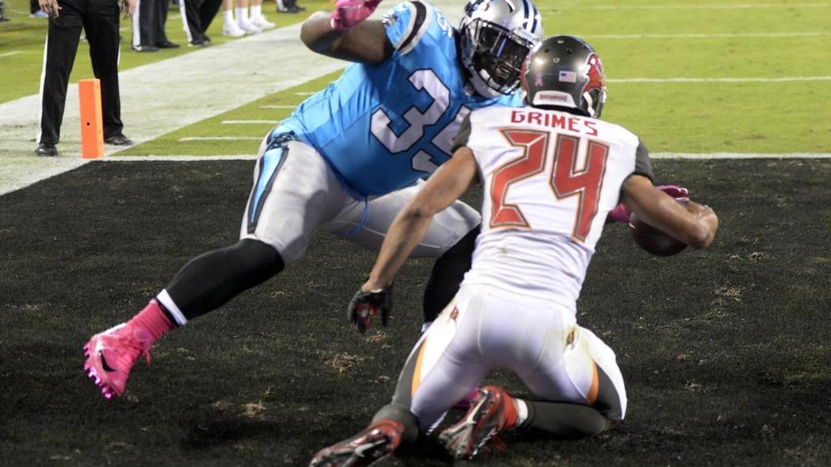 Carolina Panthers fullback Mike Tolbert (35) tries to knock the ball away from Tampa Bay cornerback Brent Grimes after Grimes intercepted it in the end zone during the second half at Bank of America Stadium on Monday. The Buccaneers won 17-14, dropping the Panthers to 1-4.