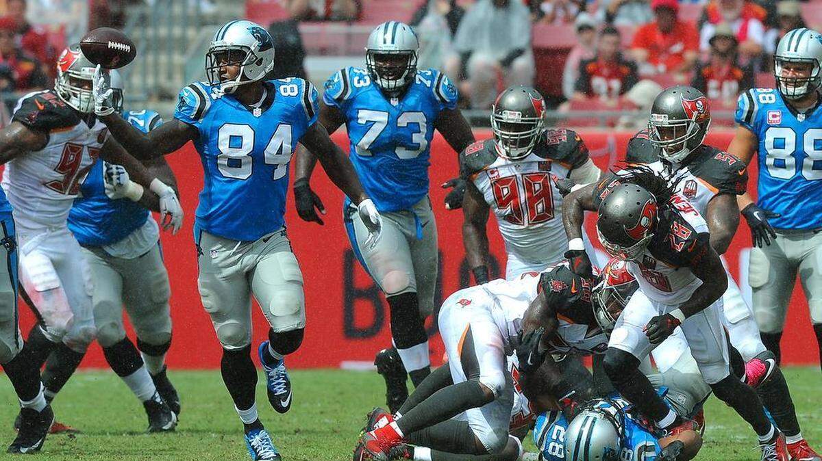 
Panthers tight end Ed Dickson, left, recovers a fumbled ball by running back Jonathan Stewart, center, as he is hit by the Tampa Bay defense during the third quarter on Sunday. Ed Dickson ran the fumbled ball for a touchdown.
