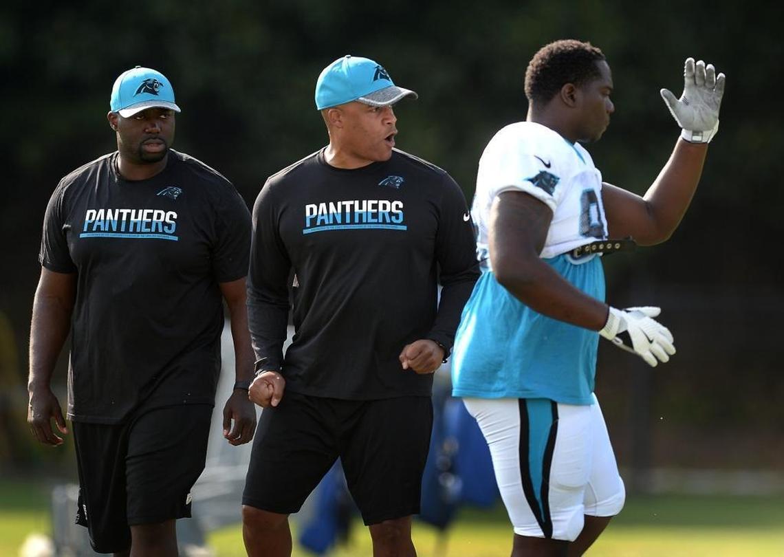 Carolina Panthers defensive coordinator Eric Washington, center, has head coaching aspirations he says can’t be realized without success in the job he has now.