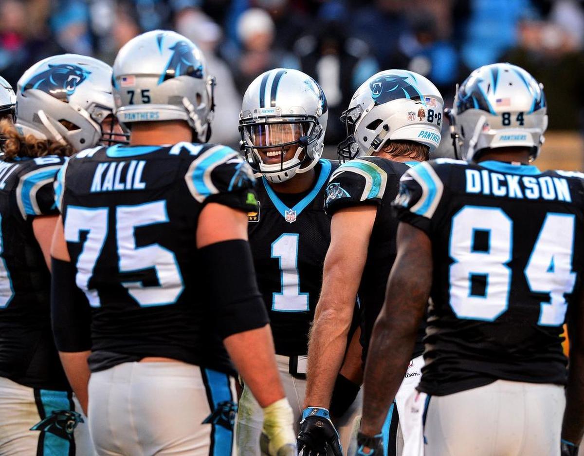 Carolina quarterback Cam Newton, center, smiled in the huddle in a 2017 win over Minnesota.