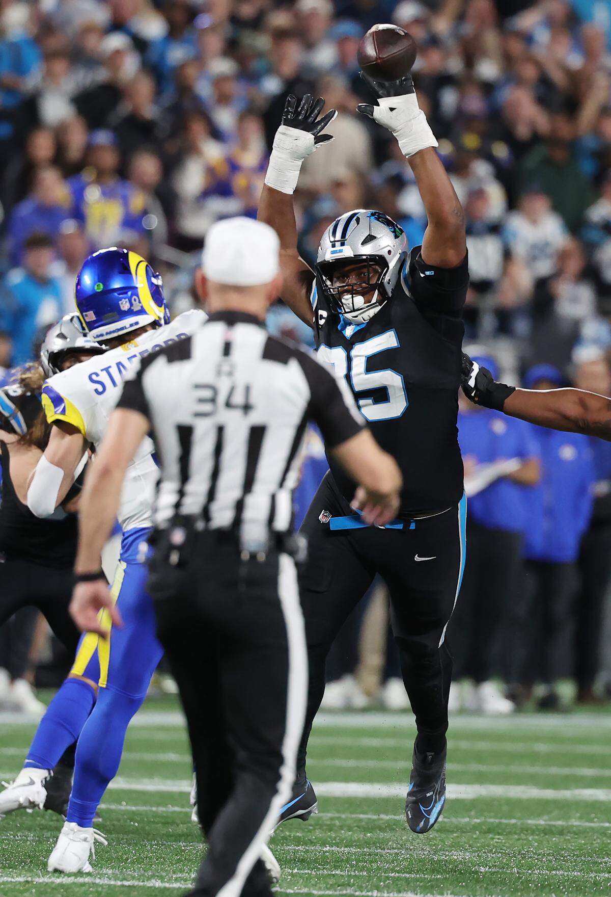 Carolina Panthers defensive tackle Derrick Brown blocks a kick by Los Angeles Rams Matthew Stafford during Saturday’s playoff game at Bank of America Stadium.