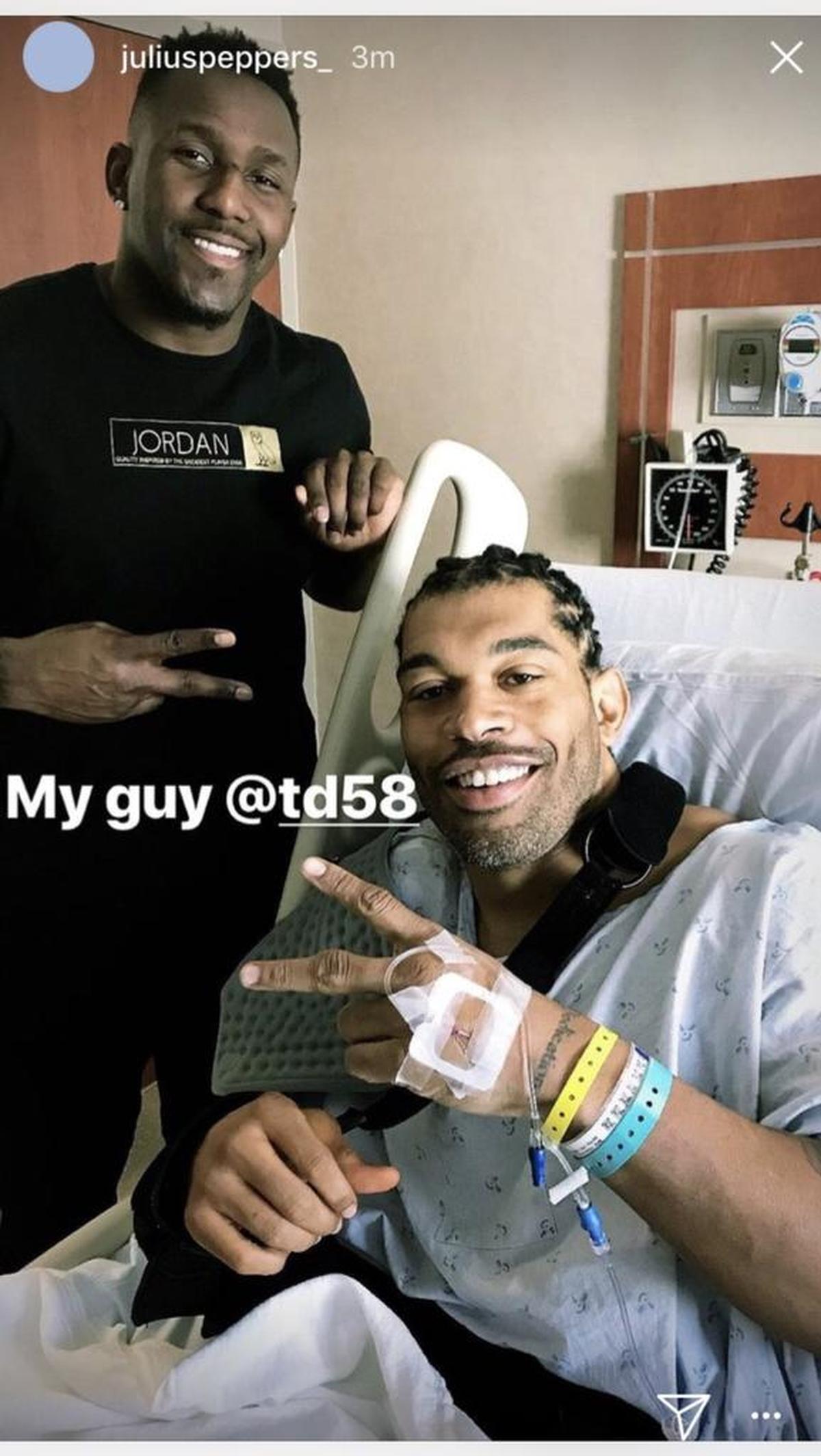 Carolina Panthers defensive end Julius Peppers (right) had surgery on his right shoulder Thursday. Linebacker Thomas Davis (left) visited him post-operation.