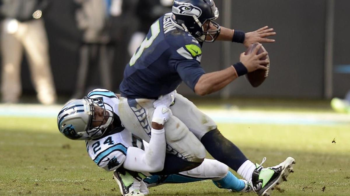 Carolina Panthers cornerback Josh Norman (24) sacks Seattle Seahawks' Russell Wilson (3) in the third quarter during their NFC Divisional game at Bank of America Stadium on Sunday. The Panthers won 31-24, and will play in the Arizona Cardinals in the NFC Championship next week.