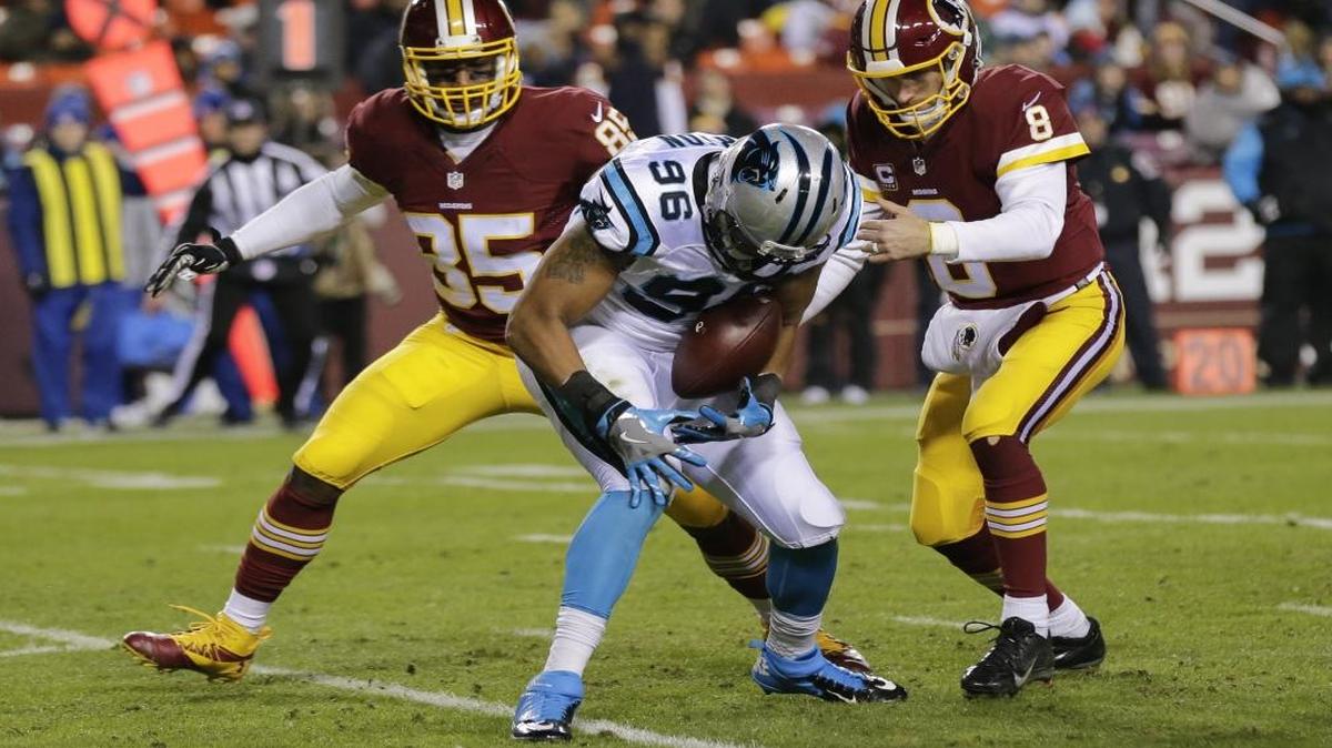 Panthers defensive end Wes Horton grabs a fumble by Washington quarterback Kirk Cousins (8) as tight end Vernon Davis (85) closes in during the second half Monday.