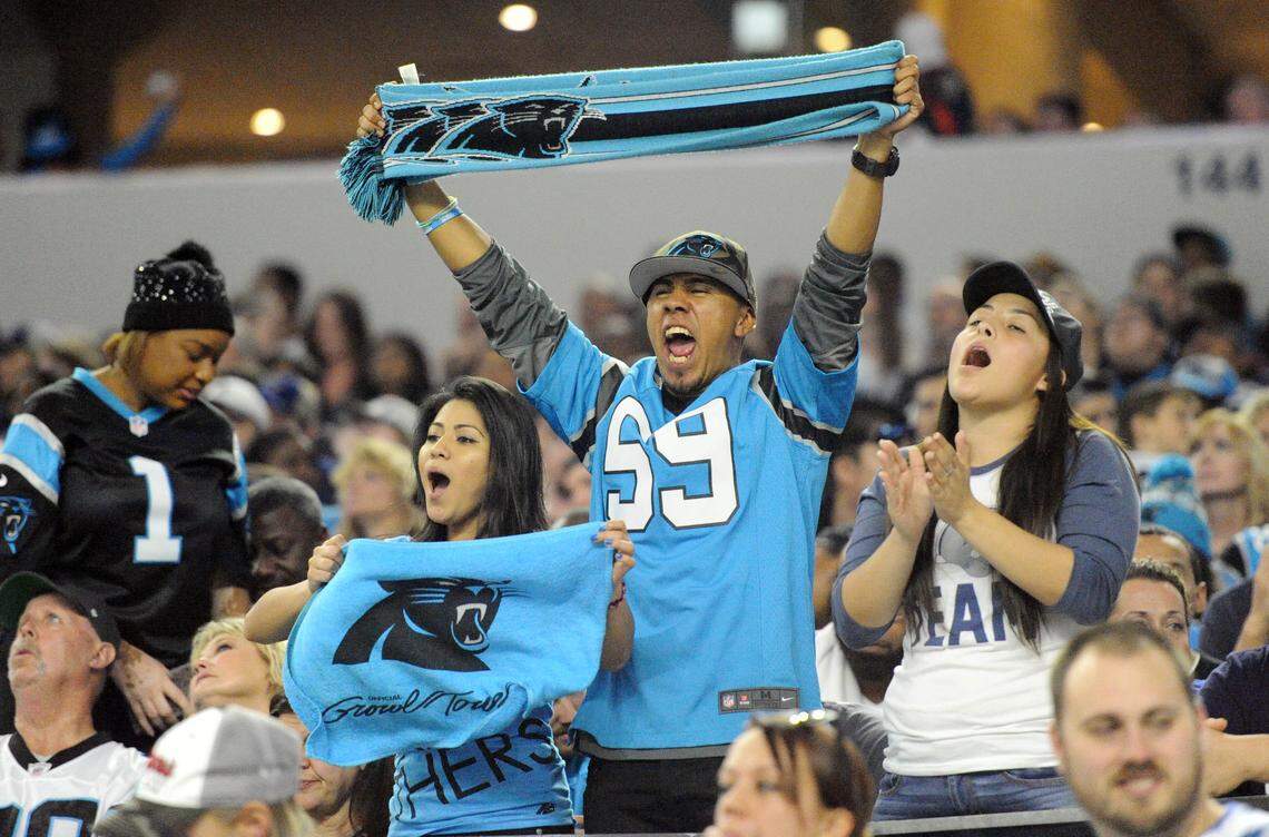 Carolina Panthers fans cheer for their team against the Dallas Cowboys at AT&T Stadium on Thursday, November 26, 2015. The Panthers won  33-14  and improved to 11-0.