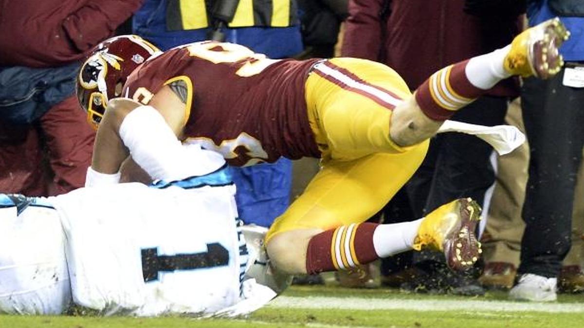 Panthers quarterback Cam Newton gets hit in the back of the helmet by Washington defensive end Trent Murphy (93) while sliding down during the first half at FedExField on Monday. Murphy was not penalized.