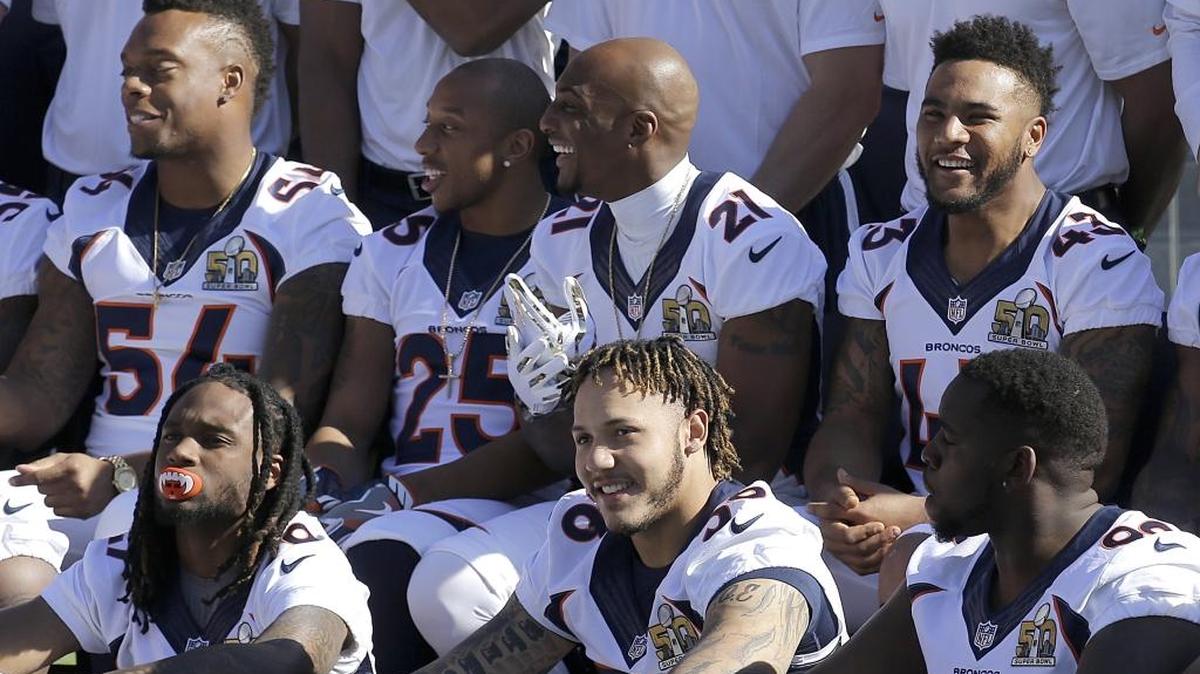 Denver Broncos linebacker Brandon Marshall (54), cornerback Chris Harris (25), cornerback Aqib Talib (21) and strong safety T.J. Ward (43) pose for team photos before an NFL football walk-through practice in Santa Clara, Calif., on Saturday.