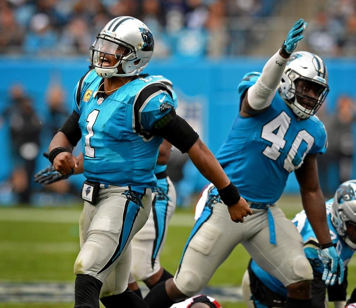 Carolina Panthers quarterback Cam Newton, left and fullback Alex Armah, right, celebrate a first down in Sunday’s game. Armah’s increase in offensive snaps against the Falcons – he had 17 – was partially due to necessity.